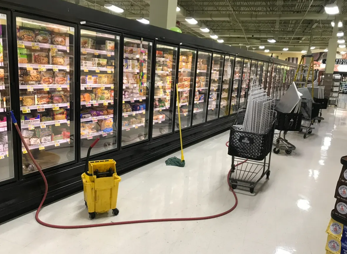 Supermarket freezer aisle with glass-door cases